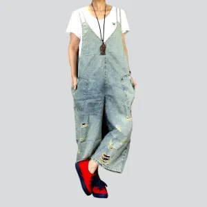 Distressed women's jean dungaree