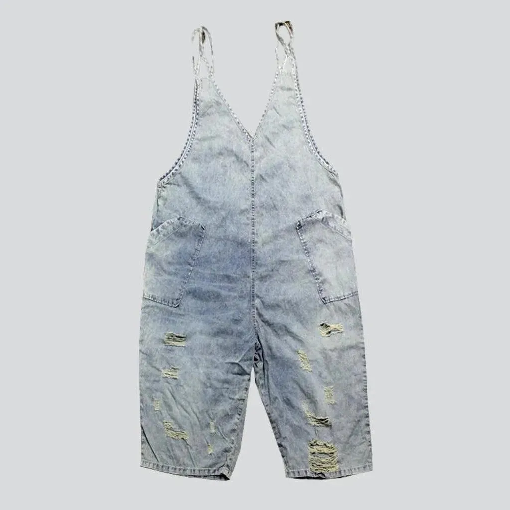 Distressed women's jean dungaree